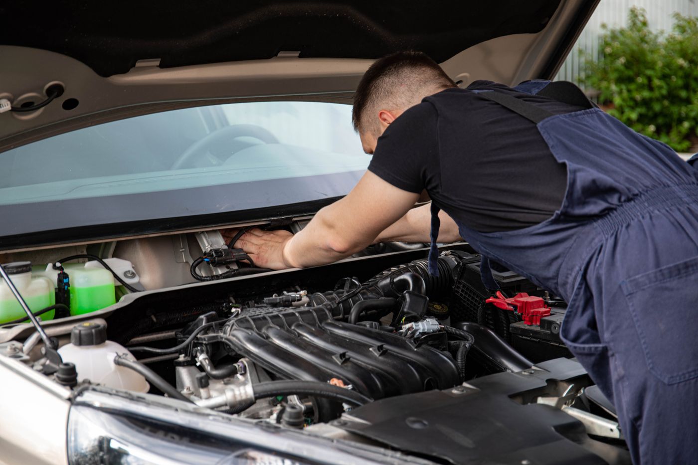 A technician working under the bonnet